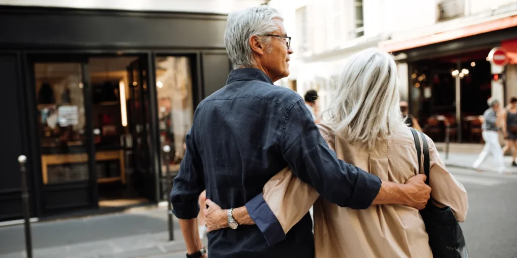 older couple hugging in the street